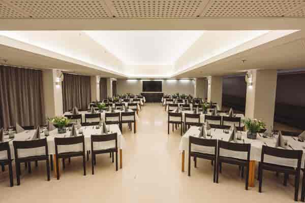 Elegant banquet hall with long tables for corporate events and social gatherings.
