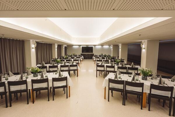 Elegant banquet hall with long tables for corporate events and social gatherings.