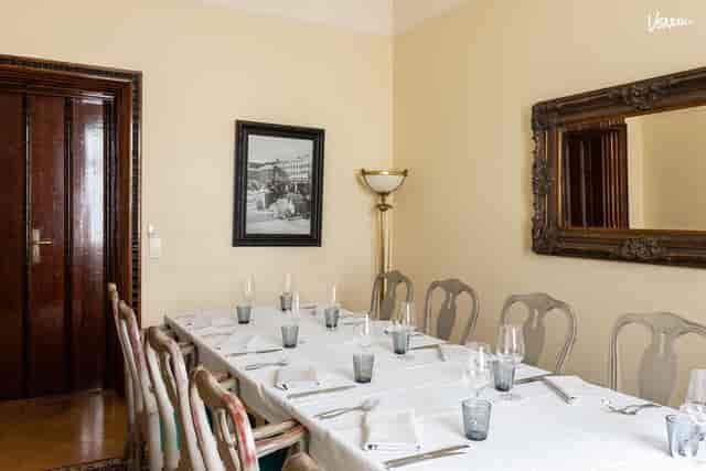 Elegant dining room with white linens, perfect for formal meetings and events.