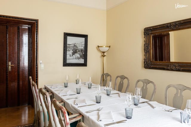 Elegant dining room with white linens, perfect for formal meetings and events.