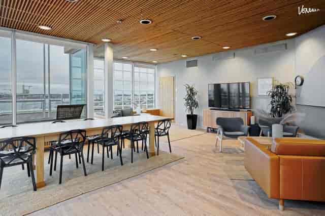 Contemporary meeting space in Santorini with natural light for workshops and networking.