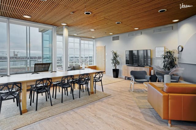 Contemporary meeting space in Santorini with natural light for workshops and networking.