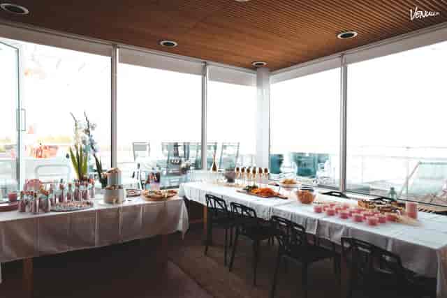 Elegant event space in Santorini with natural light, perfect for networking and celebrations.