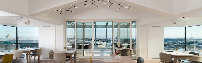 Modern Sky Lounge at VillageWorks with large windows, ideal for meetings and social gatherings.