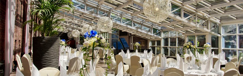 Elegant wedding venue at Talvipuutarha with floral centerpieces and refined decor.