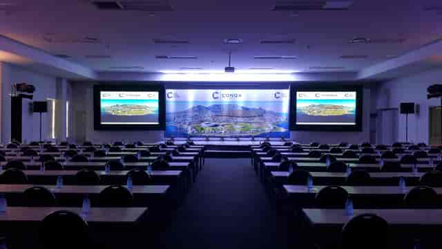 Conference setup at V&A Waterfront with organized tables, chairs, and presentation screens.