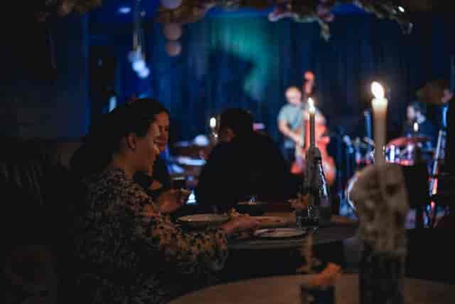Intimate cocktail bar event in The Blue Room with live music and soft lighting.
