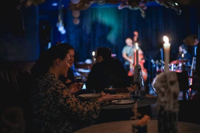 Intimate cocktail bar event in The Blue Room with live music and soft lighting.
