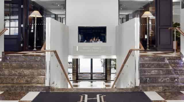 Elegant Hotel Haven auditorium entrance with marble stairs, perfect for upscale events.