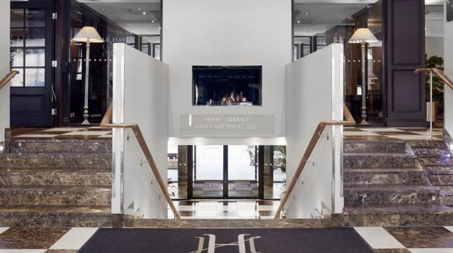 Elegant Hotel Haven auditorium entrance with marble stairs, perfect for upscale events.