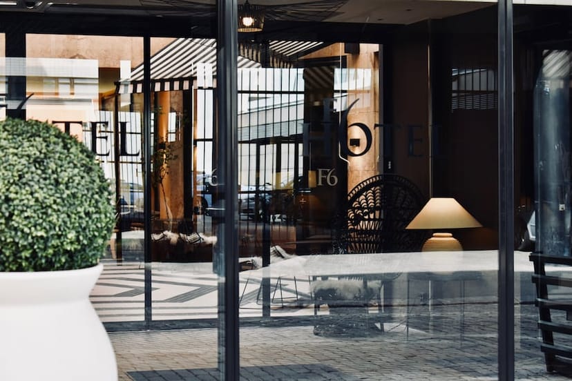 Sophisticated hotel entrance with glass doors, ideal for upscale corporate events.