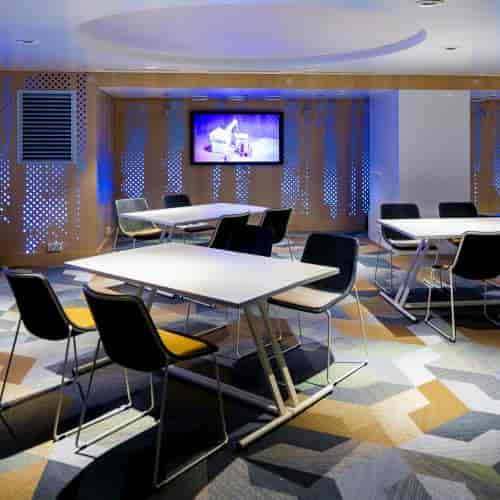 "Studio K meeting space at Klaus K Hotel with modern seating and soft lighting for events."