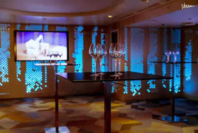 Stylish event space at Klaus K Hotel with modern tables and blue ambiance for networking receptions.