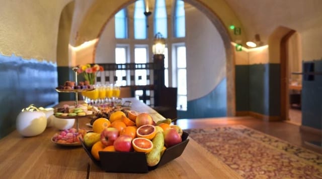 Elegant refreshment table with fresh fruits and pastries at a GLO Hotels meeting space.