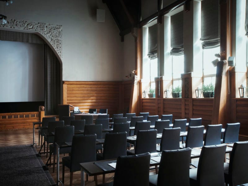 GLO Hotels conference center with arranged chairs, ideal for corporate meetings or seminars.