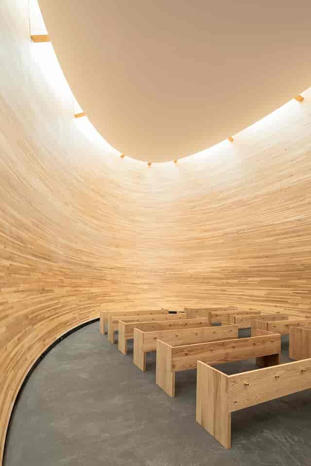 "Kamppi Chapel: modern circular venue with warm wood, perfect for intimate events."