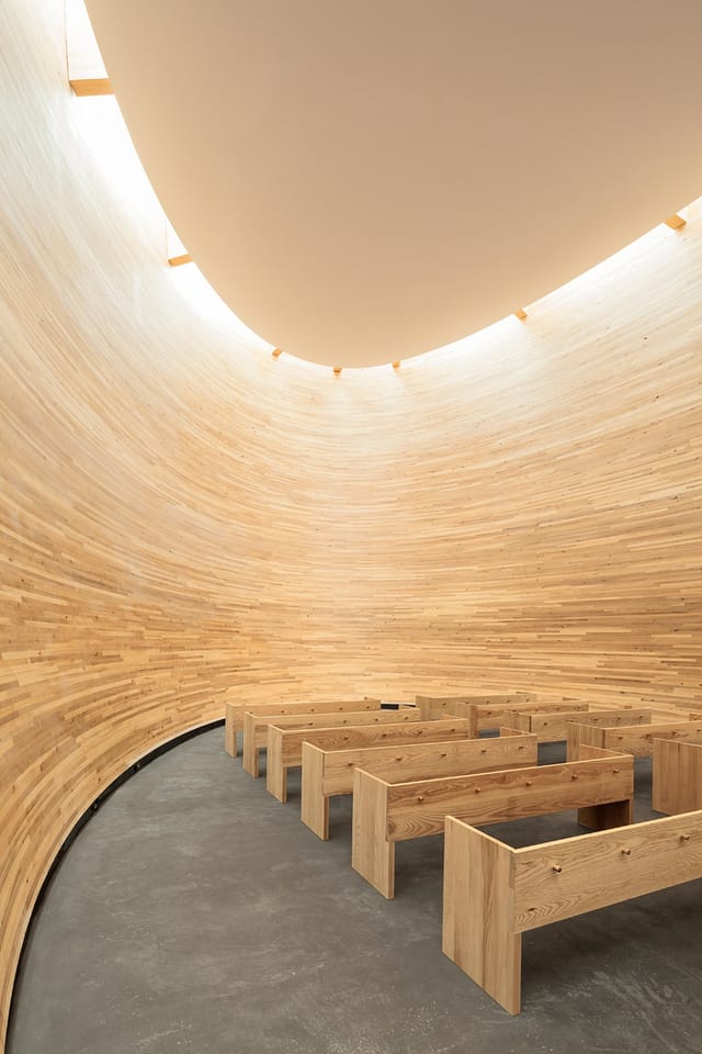 "Kamppi Chapel: modern circular venue with warm wood, perfect for intimate events."