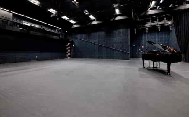 Versatile performance space in Musiikkitalo with grand piano for concerts and events.