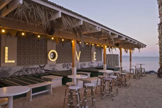 Café & Beach venue with illuminated "LOVE" sign, perfect for romantic events and gatherings.