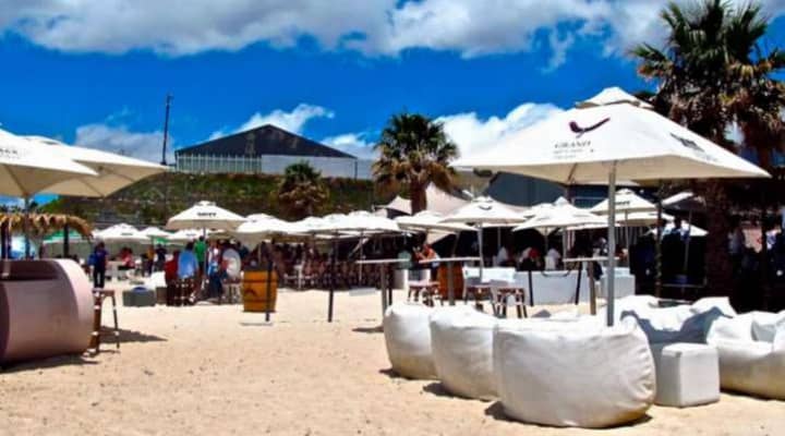 Vibrant beach event venue with umbrellas and seating for social gatherings at Grand Africa.