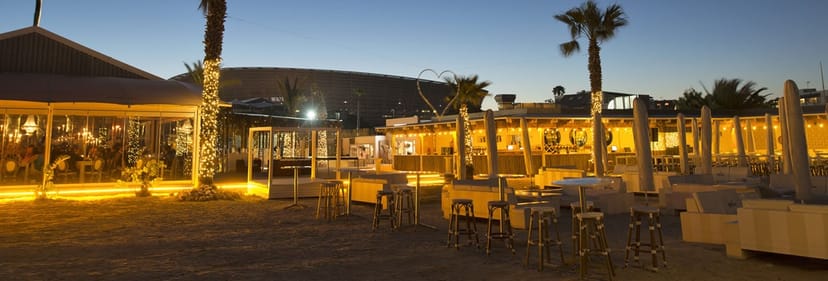 Outdoor event venue at Grand Africa Café with palm trees and stylish seating.