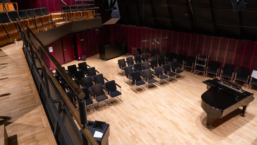 Chamber music hall at Uniarts Helsinki with grand piano, perfect for concerts and presentations.