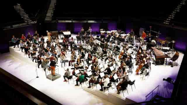 Chamber music hall at Uniarts Helsinki with orchestral ensemble, ideal for events.