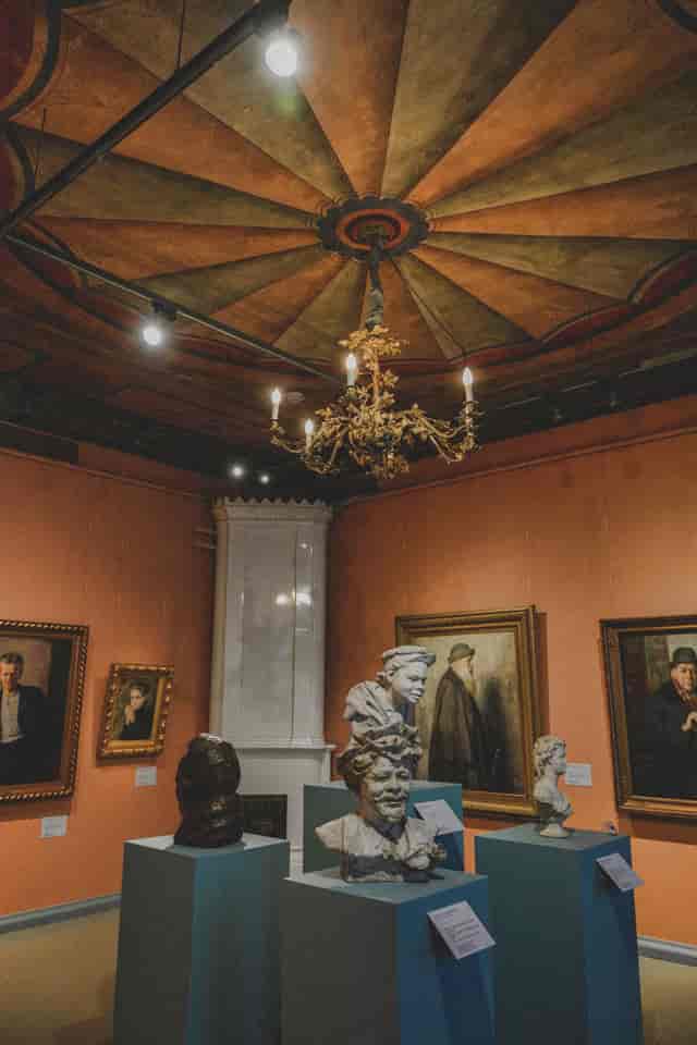 Sophisticated art gallery with sculptures, ideal for upscale events and cultural receptions.