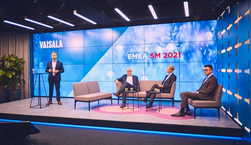 Sleek panel discussion setup at Flik Event Studios with Vaisala branding.