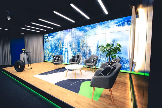 Modern event space with multi-screen backdrop for small conferences and workshops.