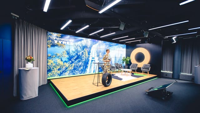 Modern event stage with vibrant backdrop for presentations and product launches.