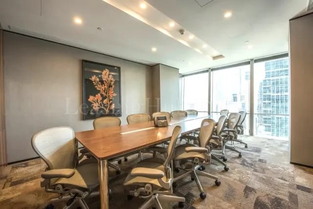 Modern conference room with wooden table and ergonomic chairs for corporate events.