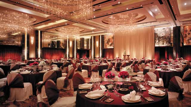 Grand Ballroom at Shangri-La Hotel Beijing, elegant banquet hall with floral centerpieces.