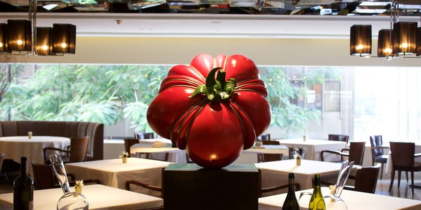 Cocktail bar with striking red pepper sculpture, ideal for upscale events and gatherings.