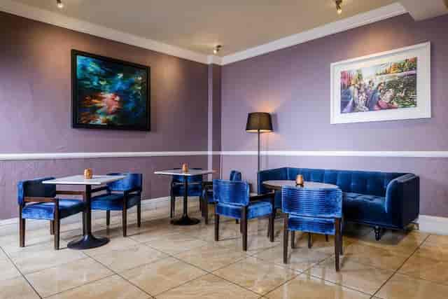 Stylish Club Lounge at Commodore Hotel with plush blue seating for networking events.
