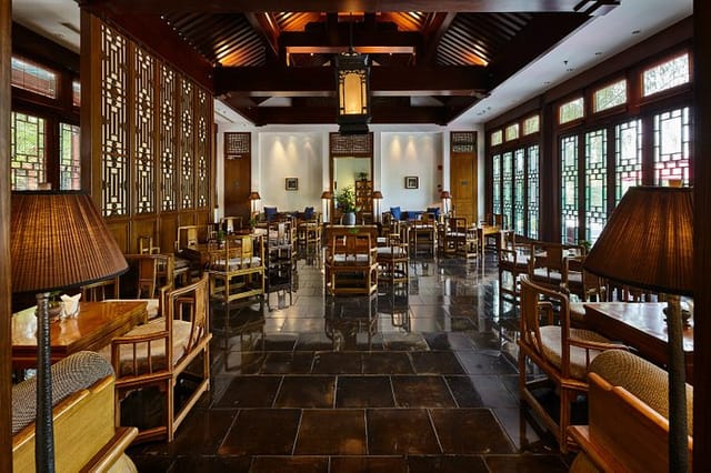 "Elegant Chinese restaurant event space with wooden accents, ideal for gatherings and networking."