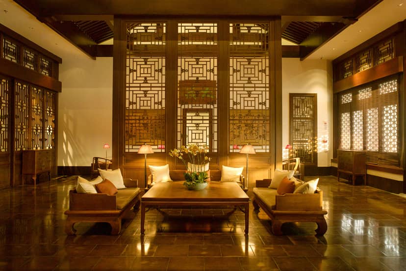 Nama餐厅 lobby with warm tones, intricate woodwork for events and meetings.