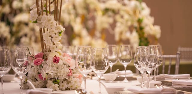 Elegant banquet table with floral centerpieces at China World Hotel, ideal for weddings.