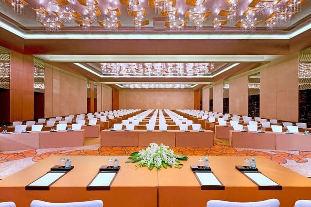 Conference Hall at Sheraton Hotel with elegant chandeliers, ideal for corporate events.