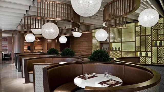 Modern Sheraton Hotel meeting room with elegant seating, ideal for networking events.