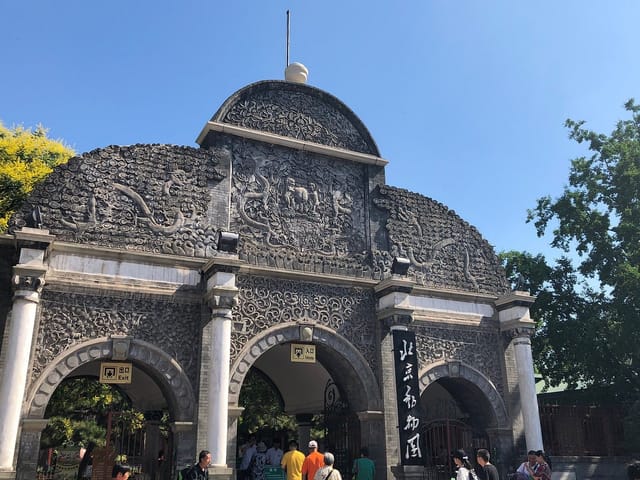 Ornate stone gateway at Beijing Zoo, perfect for themed events and cultural gatherings.