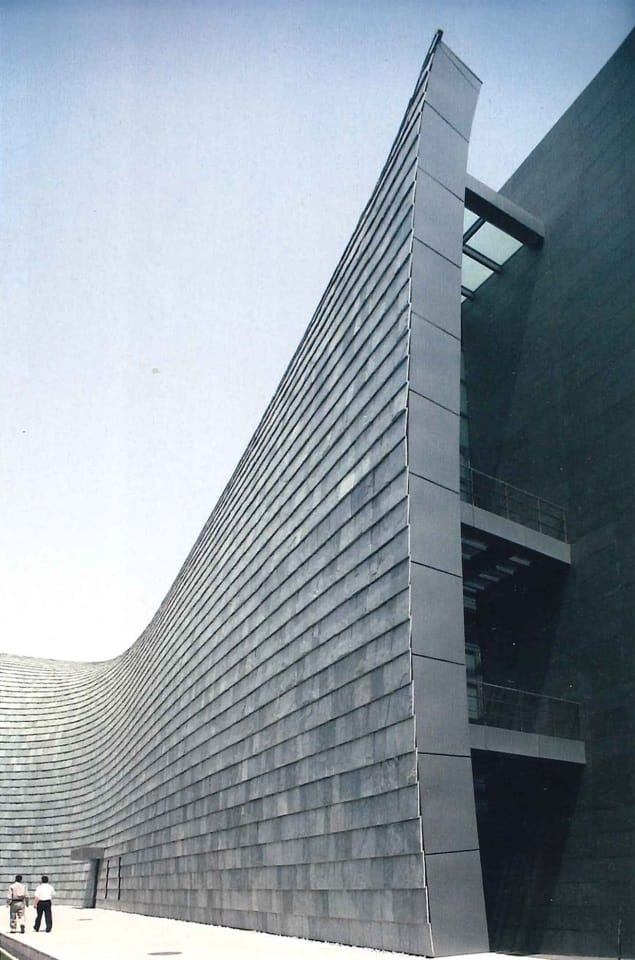 Modern exhibition hall with sleek metallic facade for innovative corporate events.
