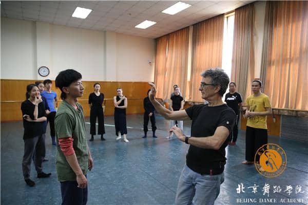 Dance studio workshop at Beijing Dance Academy, featuring dynamic instructor and diverse students.