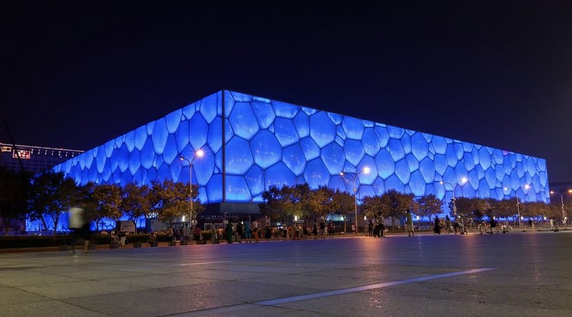 Olympic Water Cube event venue with blue lighting, perfect for gatherings and launches.