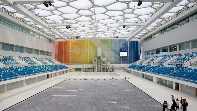 Olympic Water Cube venue with blue seating, perfect for events and presentations.
