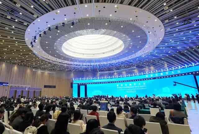 Spacious conference hall in Beijing Exhibition Center with modern design and branding.