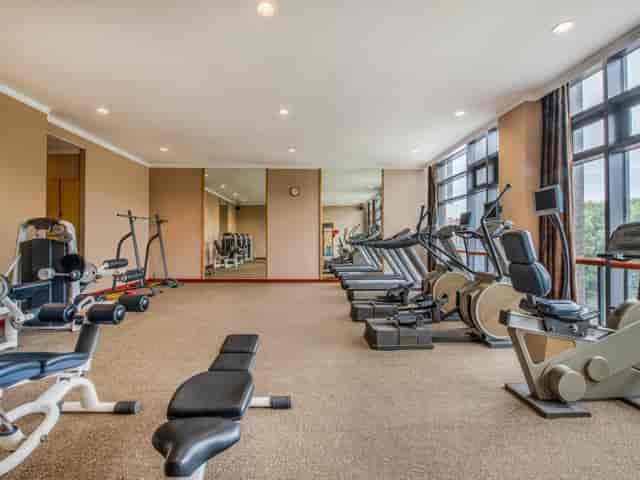 Well-lit Holiday Inn gym with cardio machines, ideal for corporate wellness retreats.