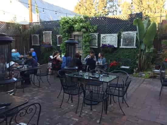 Outdoor dining area at Angelicas, featuring cozy seating for corporate gatherings or social events.