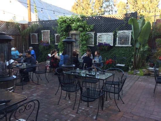 Outdoor dining area at Angelicas, featuring cozy seating for corporate gatherings or social events.