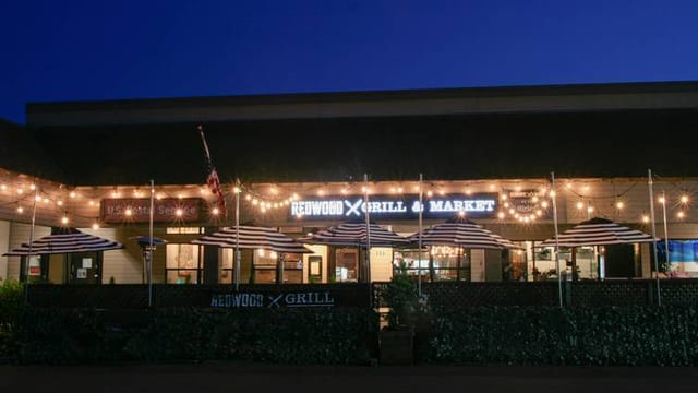 Private Barrel Room patio at Redwood Grill with string lights, perfect for casual events.
